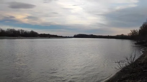 Wide View of a Calm River with Green Trees on a Sunny Summer Day Stock-Footage 297889901