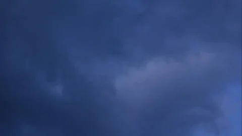 A wide view captures clouds moving steadily across bright blue space while Stock Footage 324957052