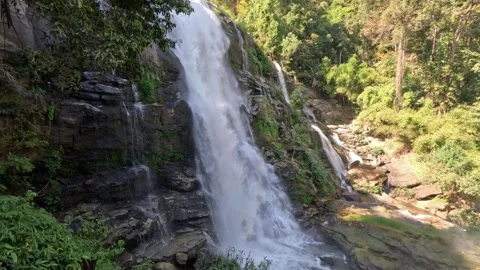 Wide View of Cascading Waterfall with Mossy Rocks in Northern Thailand Stock Footage 339921726