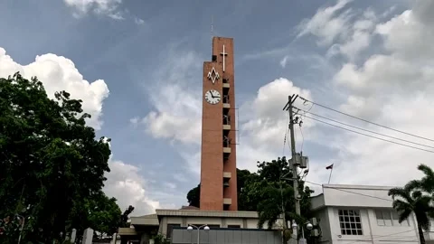 A Wide View of City Clock Tower with Bells Swinging Beside Antipolo City Church Stock Footage 242673396