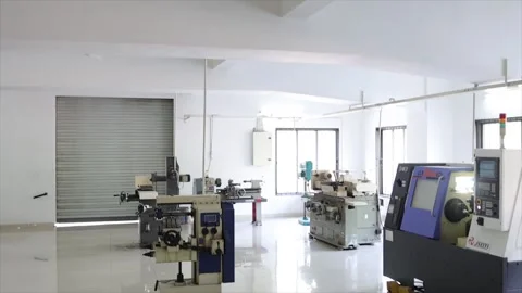Wide View of Clean Industrial Machine Shop with Lathe CNC Machines and Red Tool Stock Footage 334592855