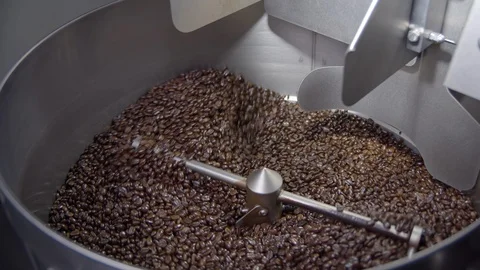 Wide view of coffee beans rotating in roaster in slow motion, 4k Stock Footage 112295152