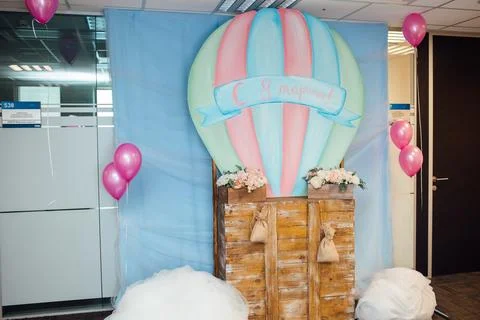 Wide view of a creative photo zone with a pastel hot air balloon and clouds set Stock Photos