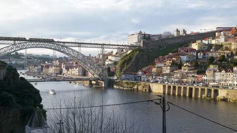 Wide view of the Dom Luis I Bridge and Ribeira waterfront from across the Douro. Stock Footage 327624734
