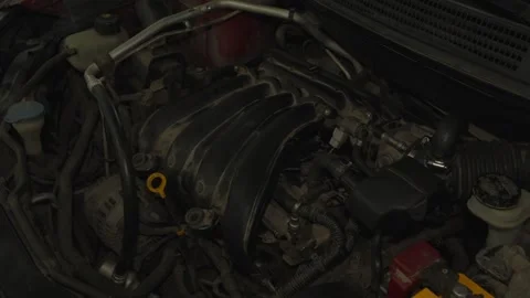Wide view of a dusty car engine bay with plastic intake manifold. Stock Footage 340559604