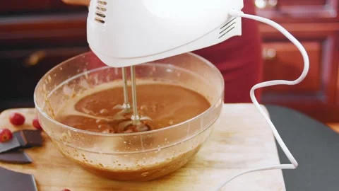 Wide view of an electric mixer working in a glass bowl, 4K Stock Footage 341120895