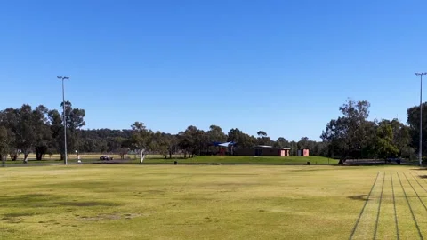 Wide View of Empty Grass Sports Field and Running Track Stock Footage 341373985