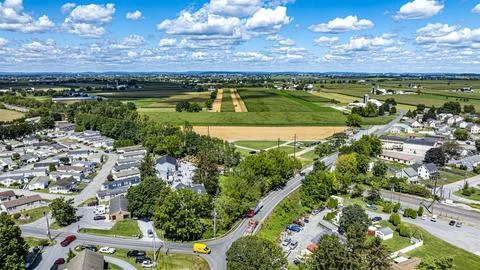 Wide View of Fields and Homes in Rural Area During Daytime in Summer Season Stock Photos
