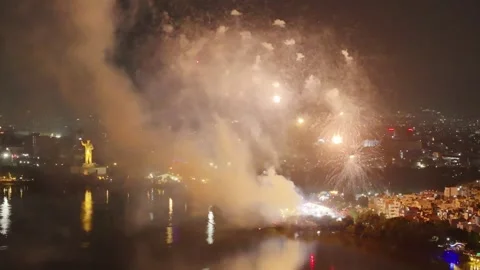 Wide view of Fireworks blast on sky with heavy smoke, illuminated city, Hussain Stock Footage 344059471
