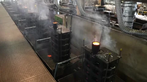 Wide view of foundry workshop with small furnace steam and stacked wooden crates Видео 344247737
