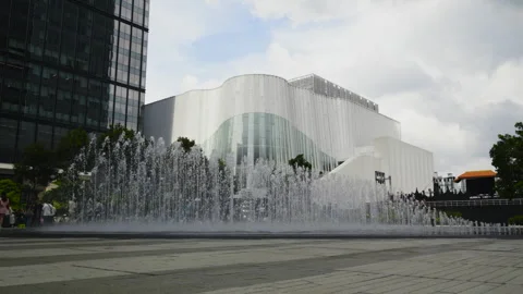 Wide view of a fountain plaza beneath a Bangkok building Stock Footage 345979110