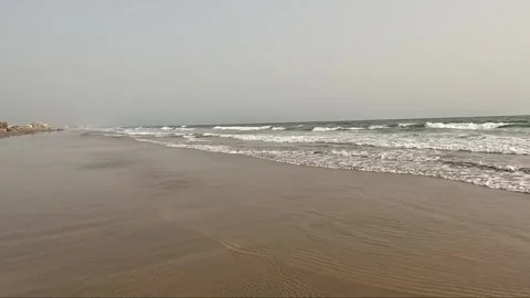 Wide view of golden sandy beach wave rolling in the sunny day Stock Footage 341466310