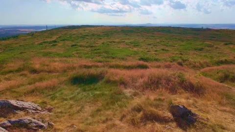 Wide view of hill summit horizon under sky with white clouds in Ireland Stock Footage 340435649