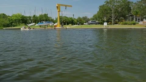 Wide View Horizontal looking across into Gulfport, Florida marina. Small boat he Stock Footage 285269345