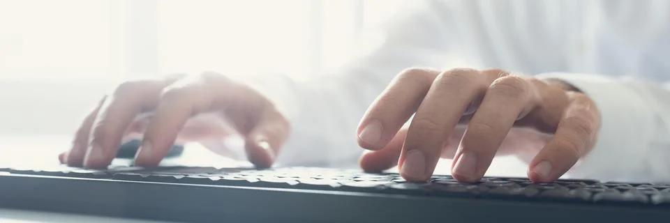 Wide view image of computer programmer typing Stock Photos