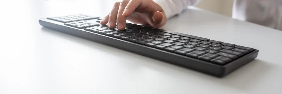 Wide view image of programmer or businessman typing on black computer keyboar Stock Photos