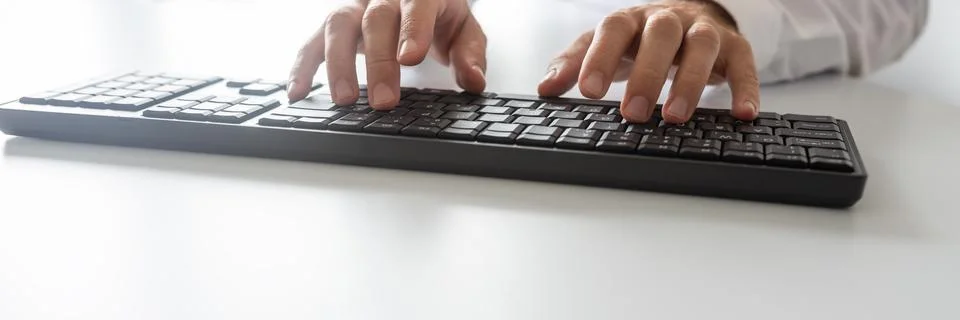 Wide view image of programmer using computer keyboard 写真素材