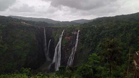 A wide view of Jog Falls showcasing cascading water and scenic natural land.. Video stock 337042449