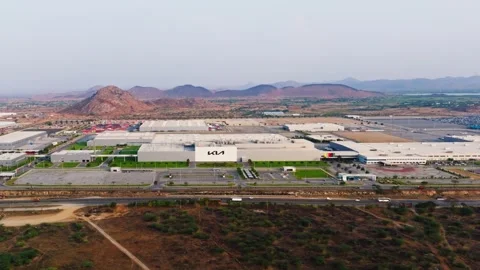 Wide view of KIA manufacturing unit with background hills and national highway Stock Footage 341179546