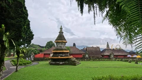 Wide view of large Balinese temple complex with stupa and palm-lined alley Stock Footage 339936408