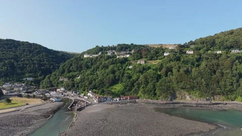 Wide View of Lynmouth Village in Devon with Houses Scattered Amongst Tree Stock Footage 341673018