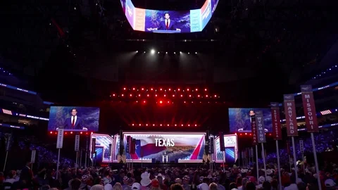 Wide view of the main stage and 'Texas' screens above the delegates Stock Footage 345271499
