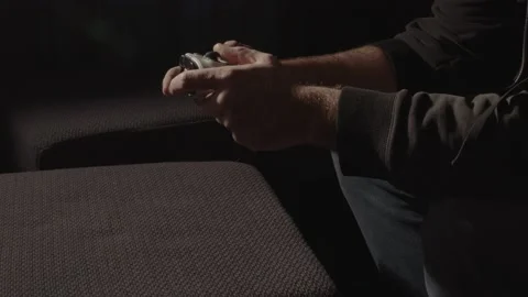 Wide view of male hands playing with videogame controller and dropping Stock Footage 221764683