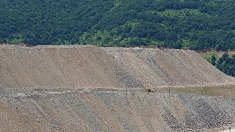 Wide view of a massive excavation pit with tiered rock walls Stock Footage 339644479