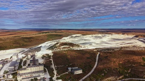 Wide view of a mining site showing large excavated areas and machinery with a Stock Footage 345457160