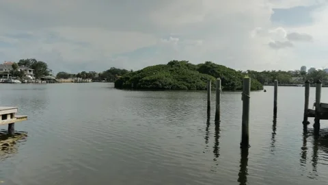 Wide view over water to Coffee Pot Bayou bird preserve a small island packed wit Stock Footage 284733741