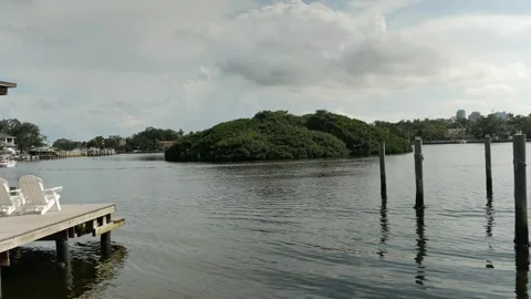 Wide view over water to Coffee Pot Bayou bird preserve a small island packed wit Stock Footage 284734037