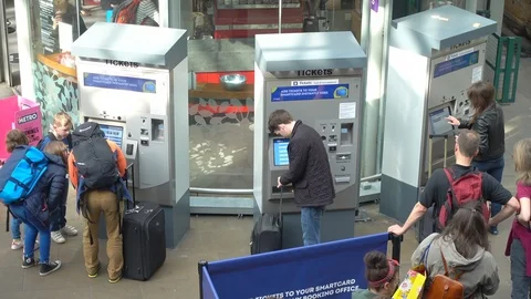 Wide view of passengers buying train tickets from self-service machines. Stock Footage 106896230