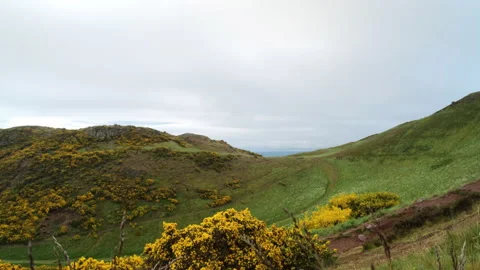 Wide view on path between two peaks, Arthur's Seat ancient volcano on cloudy Stock Footage 240134470