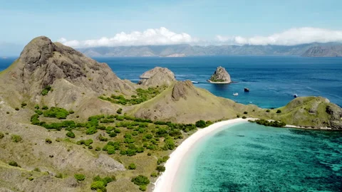 Wide view of a pink beach, high drone view going forward view Stock Footage 276159486