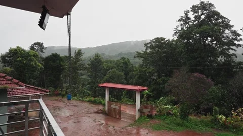 A wide view of Quiet Rainy Day at Home stay Amidst Lush Green Gardens and M.. Video stock 332352952