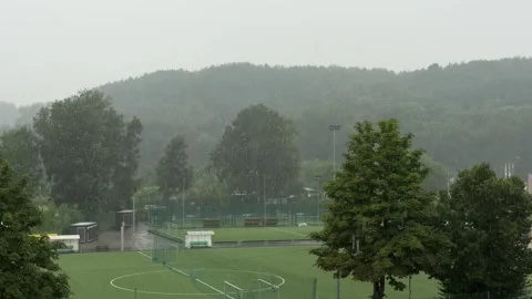 Wide View of Rainy Sports Complex Below Wooded Hills Stock Footage 340512533