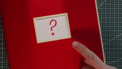 Wide view of red notebook with question mark query label Stock Footage 341269469