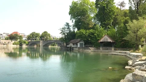 Wide view of the Rhine River with stone bridge in Rheinfelden, Switzerland Stock Footage 340230926
