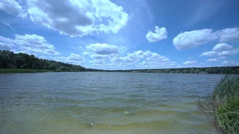Wide view of a river bank. Cloudy sky on a background. Slow motion. 스톡 동영상 123712794