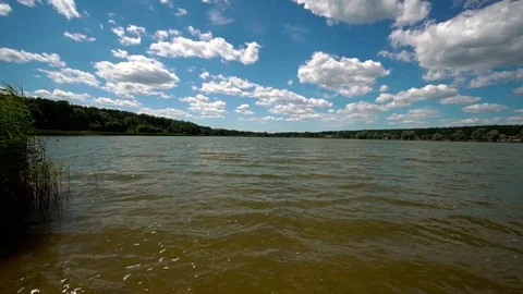 Wide view of a river bank.  Cloudy sky on the background. Slow motion. Video stock 123712859