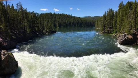Wide view of river flowing into cascades 4k 24fps Stock Footage 79278557