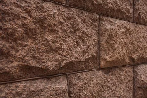 Wide view of rough stone wall with textured surface and clear lines showing.. Stock Photos
