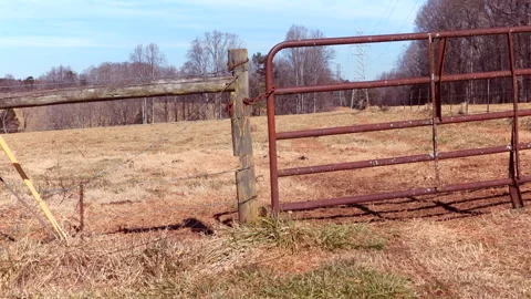 Wide View Of A Rusty Gate Held To A Wooden Post Stock Footage 300741647