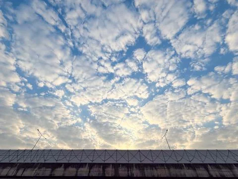 Wide view of scattered white clouds across a blue sky. Natural daylight cre.. Stock Photos