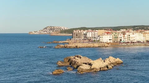 Wide view of the seaside town of LEscala, Spain, featuring a rocky shoreline in Stock Footage 346706341