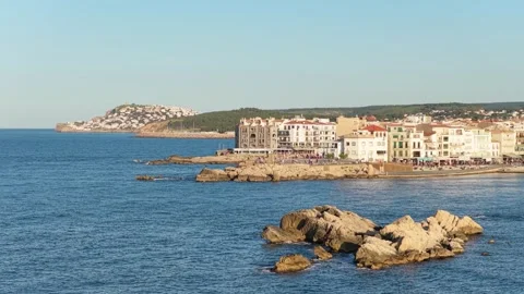Wide view of the seaside town of LEscala, Spain, showing Mediterranean waters Stock Footage 346722346