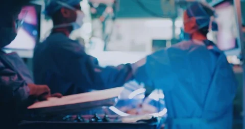 Wide View showing surgeons using Glowing Tubes in Keyhole Surgery Stock Footage 127151320