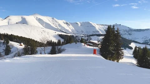 Wide view of a snow-covered ski slope in Megeve, located in the French Alps Stock Footage 346680660