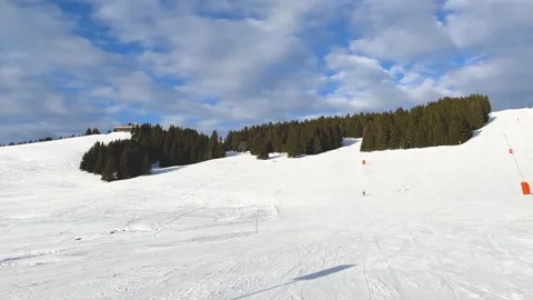 Wide view of a snowy ski slope in Megeve, located in the French Alps, Haute Stock Footage 346677211
