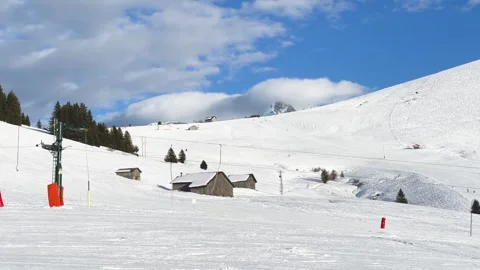 Wide view of a snowy ski slope in Megeve, Haute-Savoie, French Alps, featuring Stock Footage 346699501